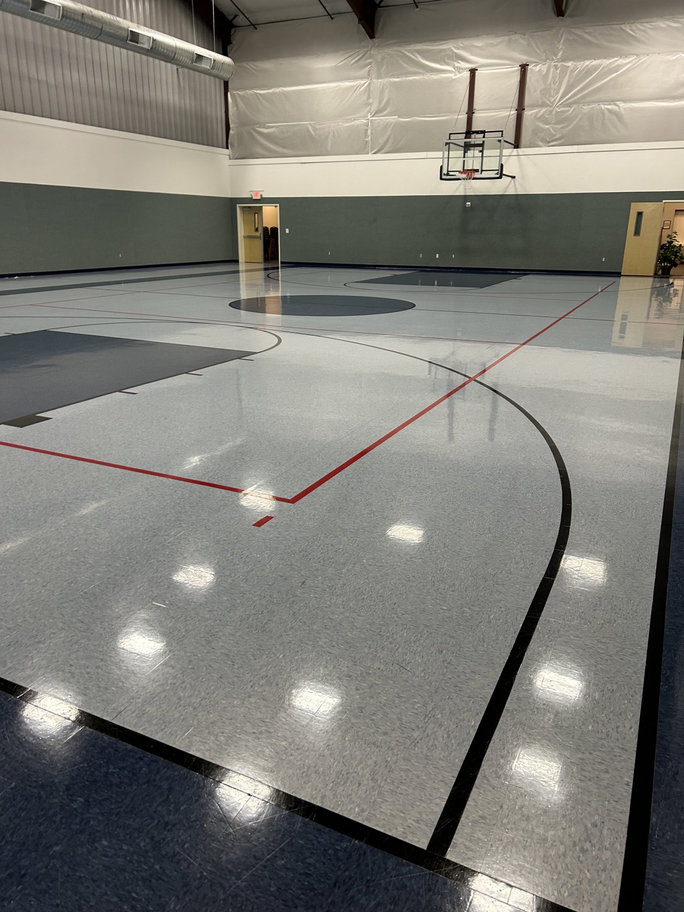High-gloss multipurpose gym court floor after refinishing