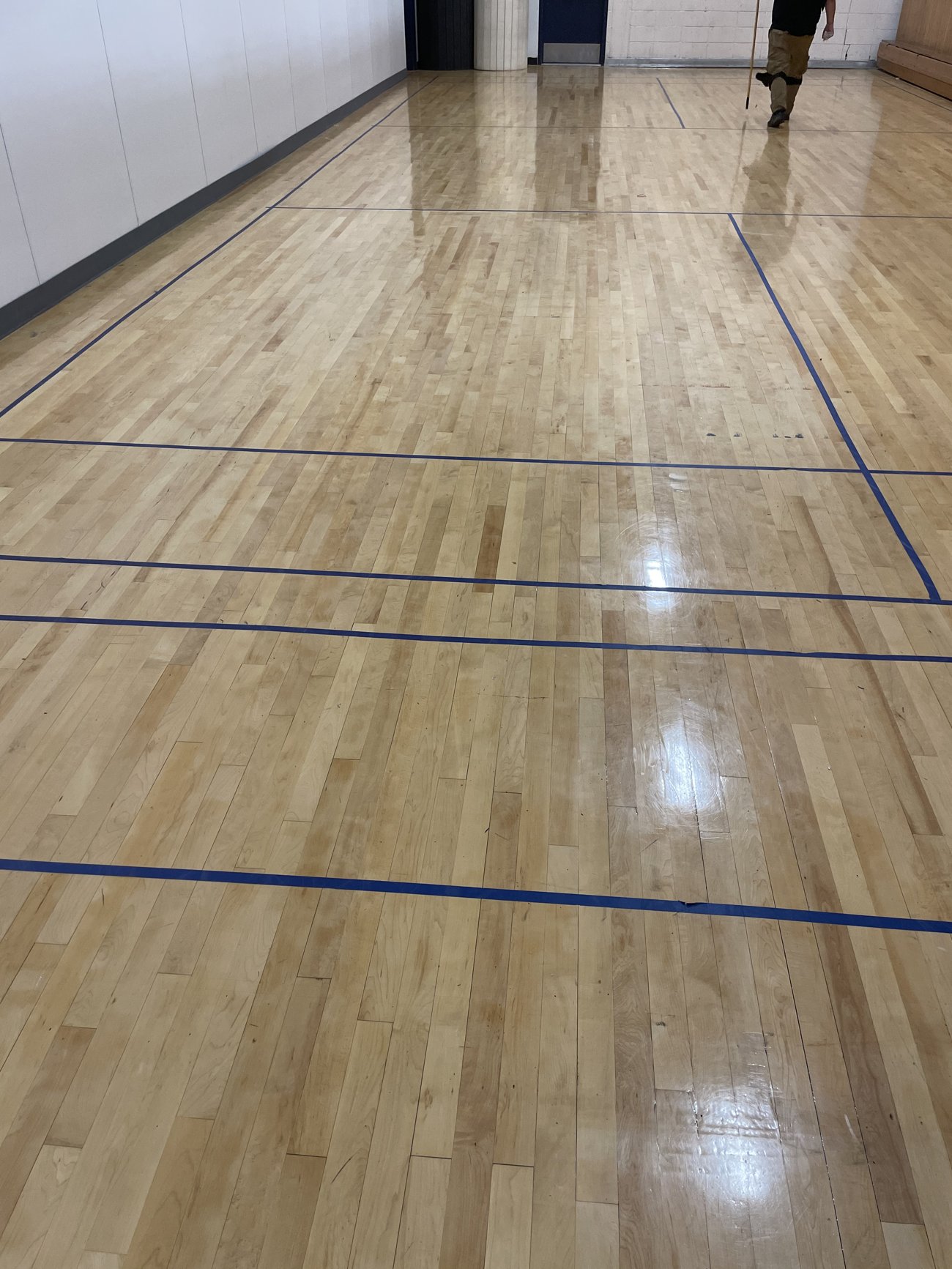 Refinished wood gym court with crisp painted game lines